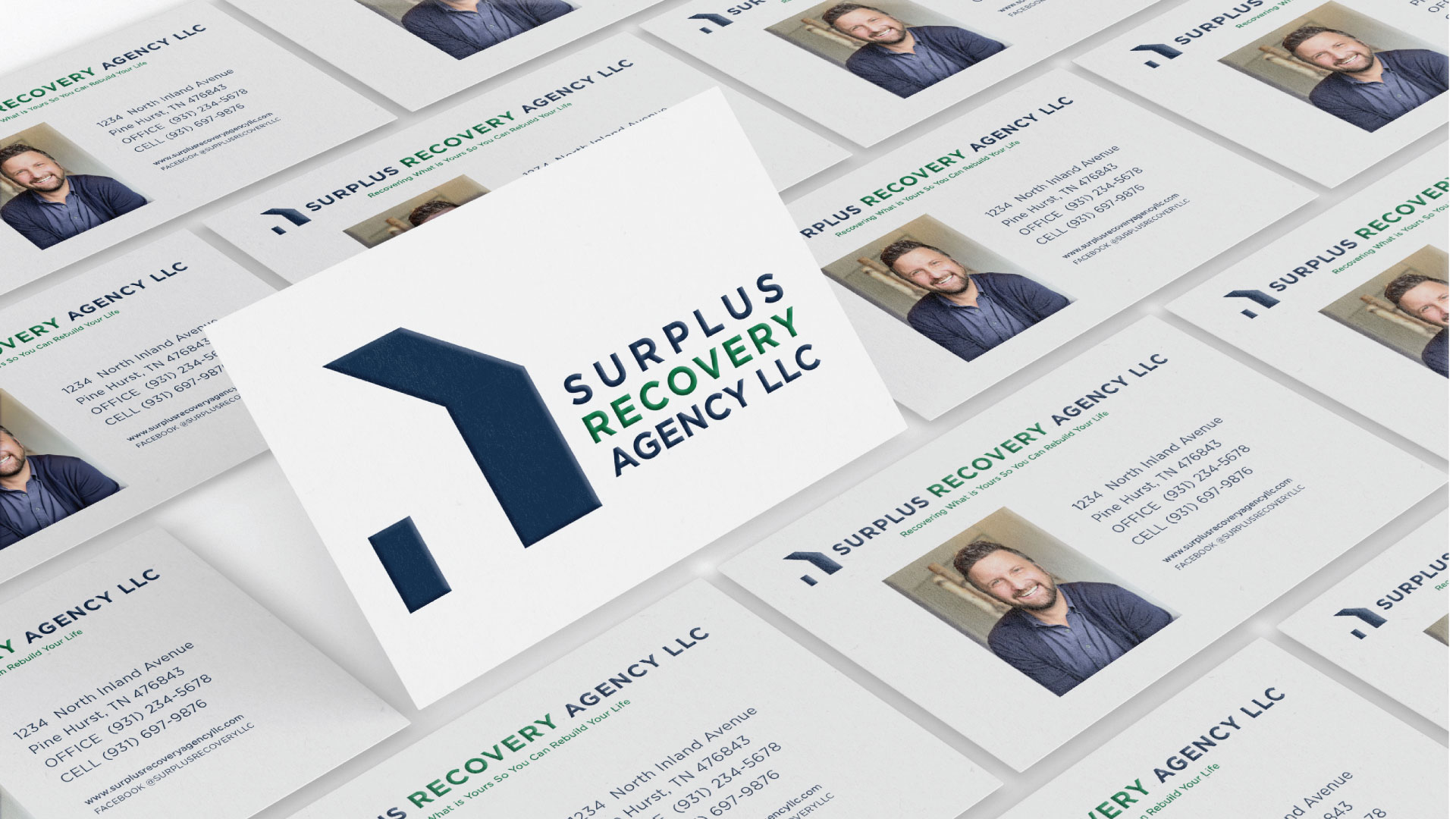 Photo of business cards for Surplus Recovery Agency LLC showing a house in negative space blue and the company name in blue and green